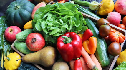 The concept of healthy food. Fresh vegetables, fruits in a wooden box. On a wooden background. Top view. Copy space.