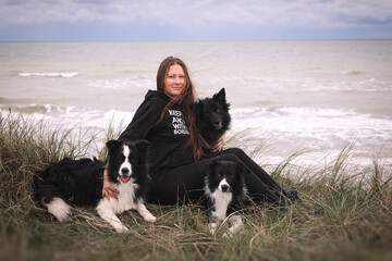 Woman with her dogs near the sea