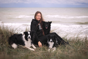 Woman with her dogs near the sea