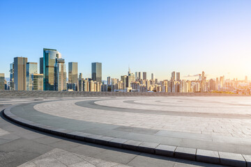 City square and skyline with modern buildings at sunset