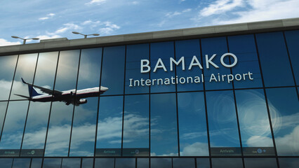 Airplane landing at Bamako Mali airport mirrored in terminal - obrazy, fototapety, plakaty