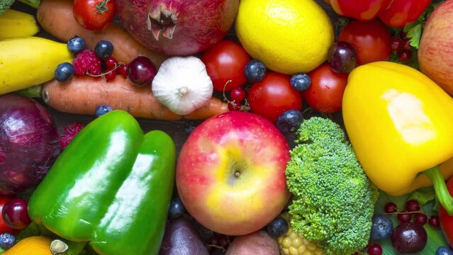 Assortment of fresh harvested fruits, vegetables and berries on the table. Healthy diet vegan and vegetarian food. top view