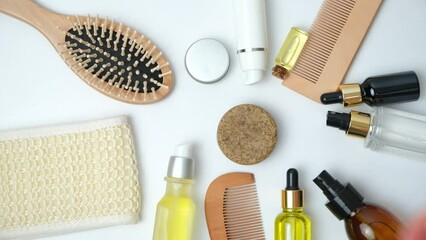 Woman putting solid shampoo to a set of natural eco-friendly cosmetics for hair care.