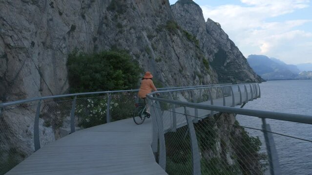 Seniour woman on the bike riding slowly at the Most beautiful bicycle rout in the world, 