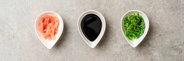 Gordijnen Soy sauce, wasabi and ginger on stone table © One Pixel Studio