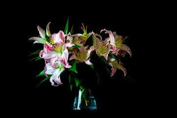Large bouquet of lily flowers in a transparent vase