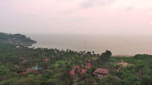 Goa, India: Aerial view of famous Indian summer resort by Arabian Sea, famous Sinquerim Beach and Sinquerim Fort at sunset - landscape panorama of South Asia from above
