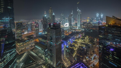 Panorama showing futuristic skyscrapers in financial district business center in Dubai night...