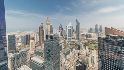 Fototapeta premium Panorama showing futuristic skyscrapers in financial district business center in Dubai on Sheikh Zayed road timelapse