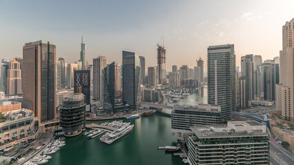 Obraz premium Panorama showing overview to JBR and Dubai Marina skyline with modern high rise skyscrapers waterfront living apartments aerial timelapse