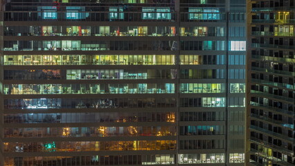 Windows of office buildings at night timelapse, the light from the windows of houses