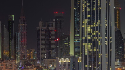 Row of the tall buildings around Sheikh Zayed Road and DIFC district aerial all night timelapse in...