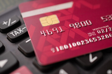 Closeup of credit card with calculator