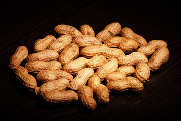 Closeup of roasted peanuts with shell on table