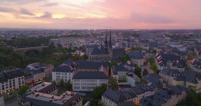 Flying a drone over the historical center of Luxembourg city in the summer in the evening at sunset