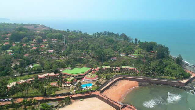 Goa, India: Aerial view of Indian summer resort by Arabian Sea, famous Sinquerim Beach and Sinquerim Fort - landscape panorama of South Asia from above
