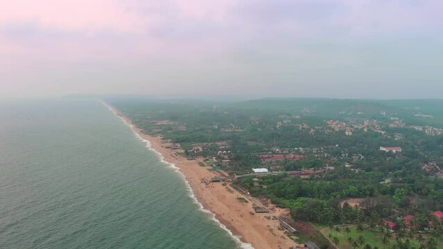 Goa, India: Aerial view of Indian summer resort by Arabian Sea, famous Goa Beaches (Sinquerim, Candolim, Calangute and Baga Beach) at sunset - landscape panorama of South Asia from above