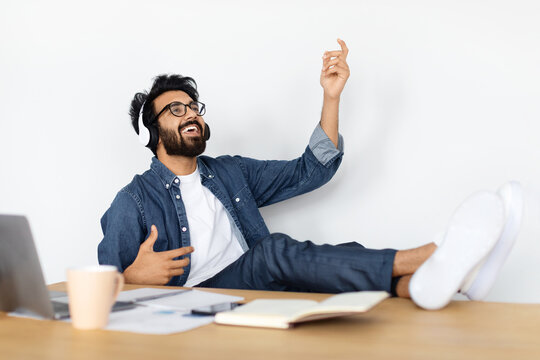 Relaxed hindu guy have break while working at home office