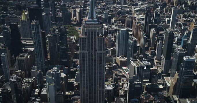 Panoramic Aerial Shot Around the Top of the Empire State Skyscraper in New York City. Helicopter View of the Spire, Viewing Platform with Tourists, Indoors Top Deck Observatory