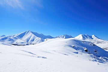 snow-covered mountain under clear, blue sky