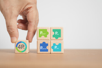 hand arranged 4P Marketing mix, Product Place Price Promotion,   white text in multi color jigsaw symbol on wooden cube blocks with copy space