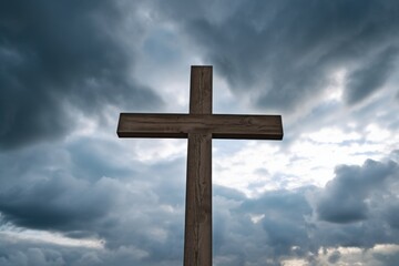 wooden cross under dramatic stormy sky