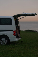 Campervan at dawn with a man's legs