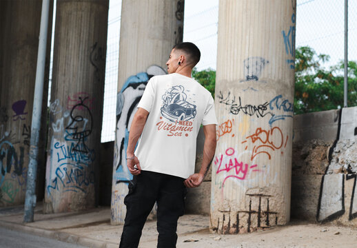 Mockup of man wearing t-shirt with customizable under flyover