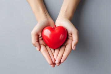 Two hands tenderly holding a vibrant red heart, symbolizing the profound and compassionate connection between individuals in a simple yet powerful gesture of love and care. Ai generated