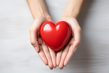 Two hands tenderly holding a vibrant red heart, symbolizing the profound and compassionate connection between individuals in a simple yet powerful gesture of love and care. Ai generated