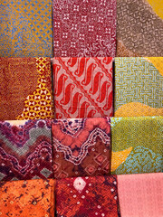 Colourful batik cloth hanging neatly on the display of a boutique