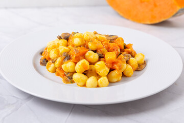 Gnocchi with pumpkin and mushrooms. Healthy and vegetarian autumn dish.