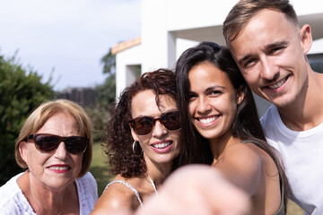 Smiless young girl taking a selfie with her family by themselves during their vacation