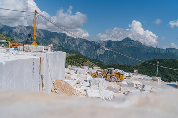 Blocks of cut white Carrara marble in the quarry in front of the rock face ready for transportation...