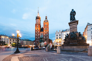 Cracow, Poland old town with St. Mary's Basilica and Adam Mickiewicz monument at the evening