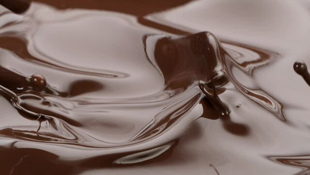 Super Slow Motion Shot of Splashing Melted Chocolate Isolated on Black Background at 1000 fps.