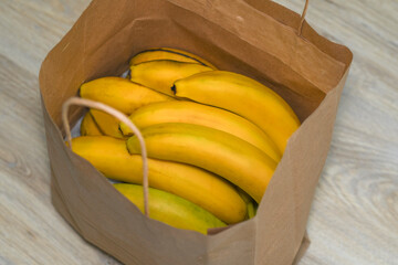 Ripe bananas lie in a paper bag.
