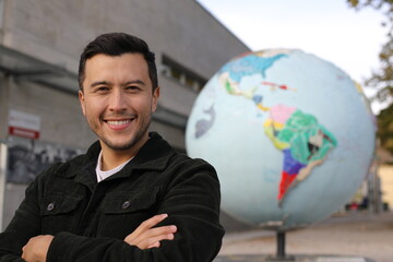 Hispanic man with the planet earth on the background  - obrazy, fototapety, plakaty
