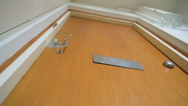 White envelope being dropped through a mail slot in the door. Low angle shot