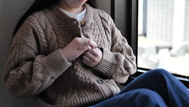 A Japanese woman taking off her clothes.