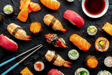 Sushi with chopsticks and soy sauce. An assortment of rolls, maki, nigiri etc, overhead flat lay...