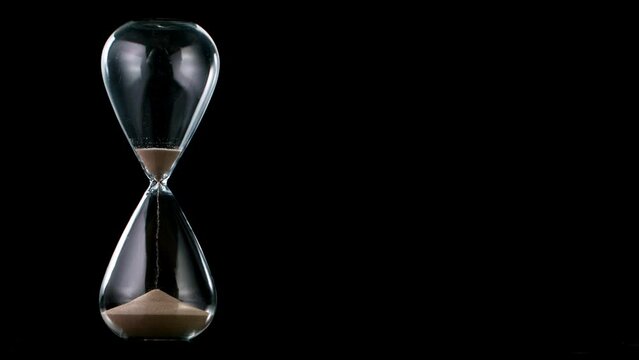 Sands move through hour glass, super slow motion filmed on high speed cinematic camera at 1000 fps