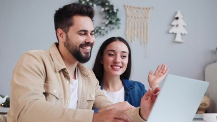 Affectionate happy couple sharing festive moments via a video call from home, connecting with distant loved ones during the Christmas and New Year celebrations, spreading warmth and holiday cheer. - Powered by Adobe