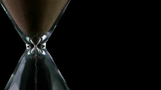 Sands move through hour glass, super slow motion filmed on high speed cinematic camera at 1000 fps