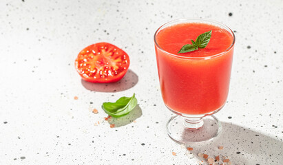Tomato juice in the glass on a light background. Long banner format