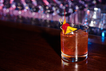 elegant thirst quenching negroni decorated with cocktail cherry on bar counter, concept