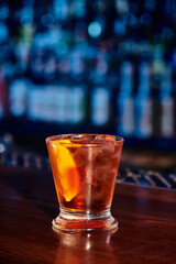 stunning zesty mai tai in lowball glass with lemon slice and ice with bar backdrop, concept