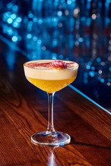 frothy tropical daiquiri with esthetic foam and flower garnishing on bar counter, concept