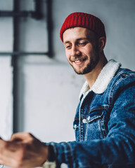 Young freelancer using phone at workplace