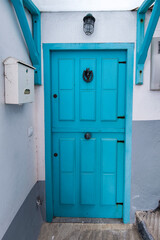 A Portal to the Past: A Blue Wooden Door in a White Wall